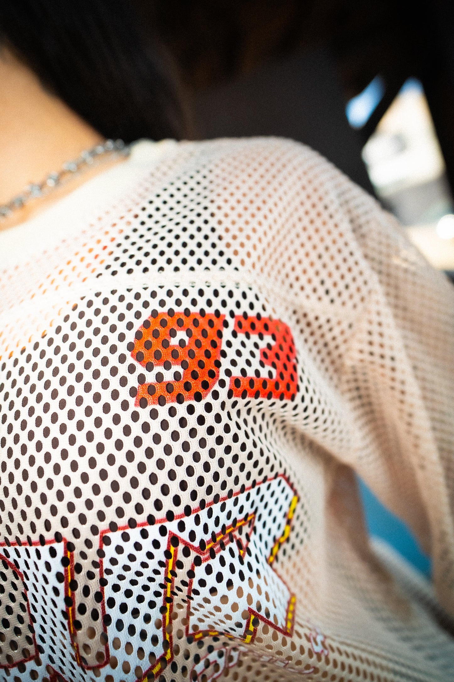 Side view of model in Raver Vibes Only Legacy Jersey – PLUR inspired rave jersey in Apricot beige with a 93 print focus, PLUR logo, and IM PEAKING back lettering. EDM festival streetwear outfit.