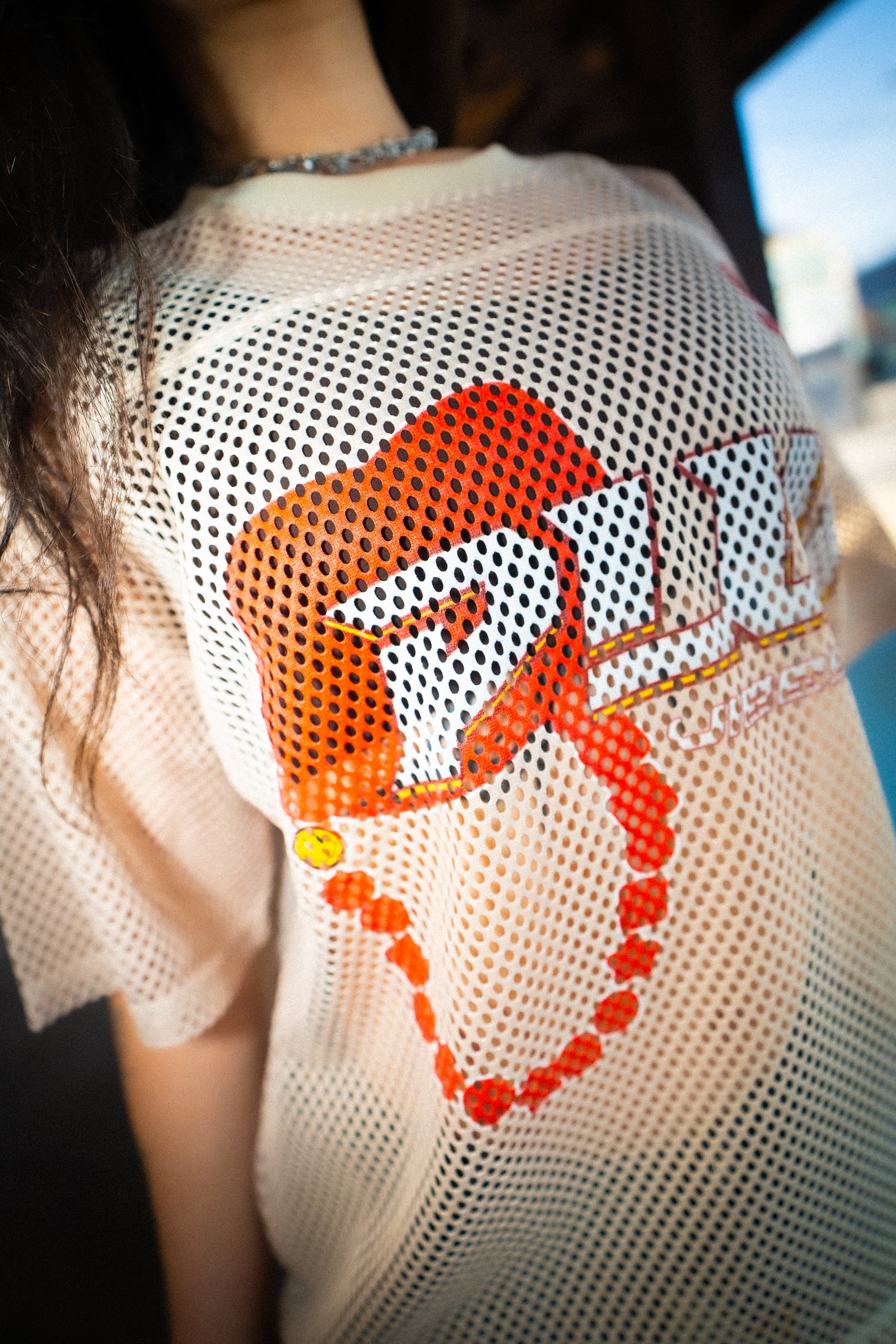Side view of model in Raver Vibes Only Legacy Jersey – PLUR inspired rave jersey in Apricot beige with 93 print, PLUR logo, and IM PEAKING back lettering. EDM festival streetwear outfit